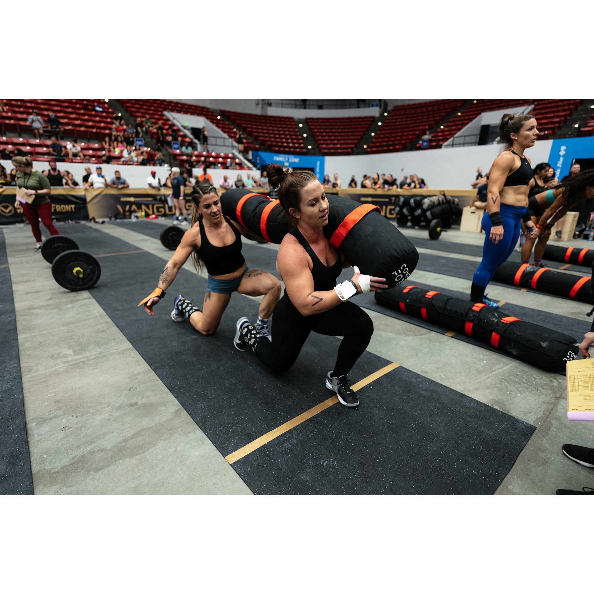 Hoisting the 2-Person Worm at HOA – Athletes lifting the 2-Person Worm in a competitive team workout at the HOA event.