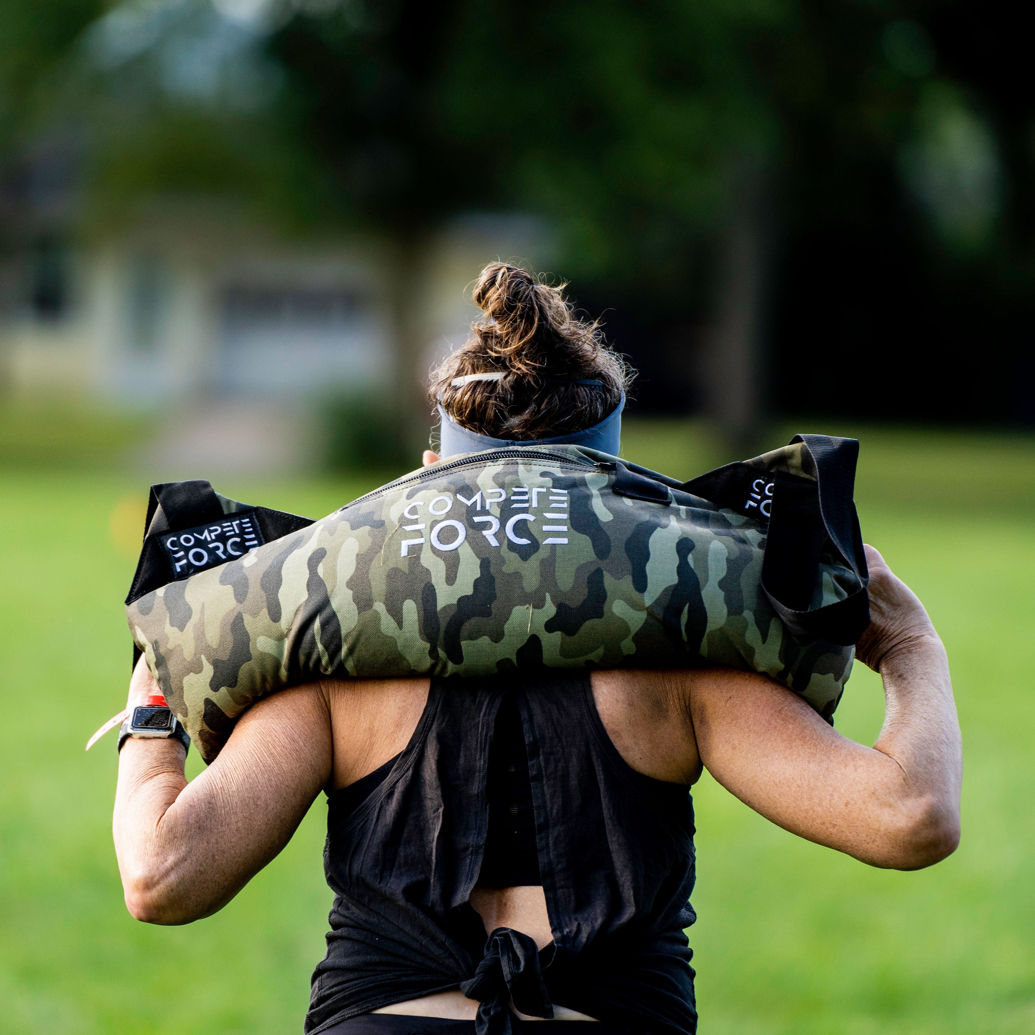 "Athletes using Compete Force Feedbags for Hyrox training, building strength, endurance, and functional fitness with versatile sandbag exercises."