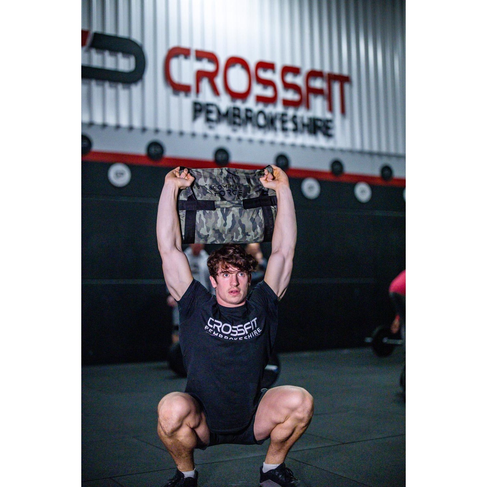 "Athletes using Compete Force Feedbags for Hyrox training, building strength, endurance, and functional fitness with versatile sandbag exercises."